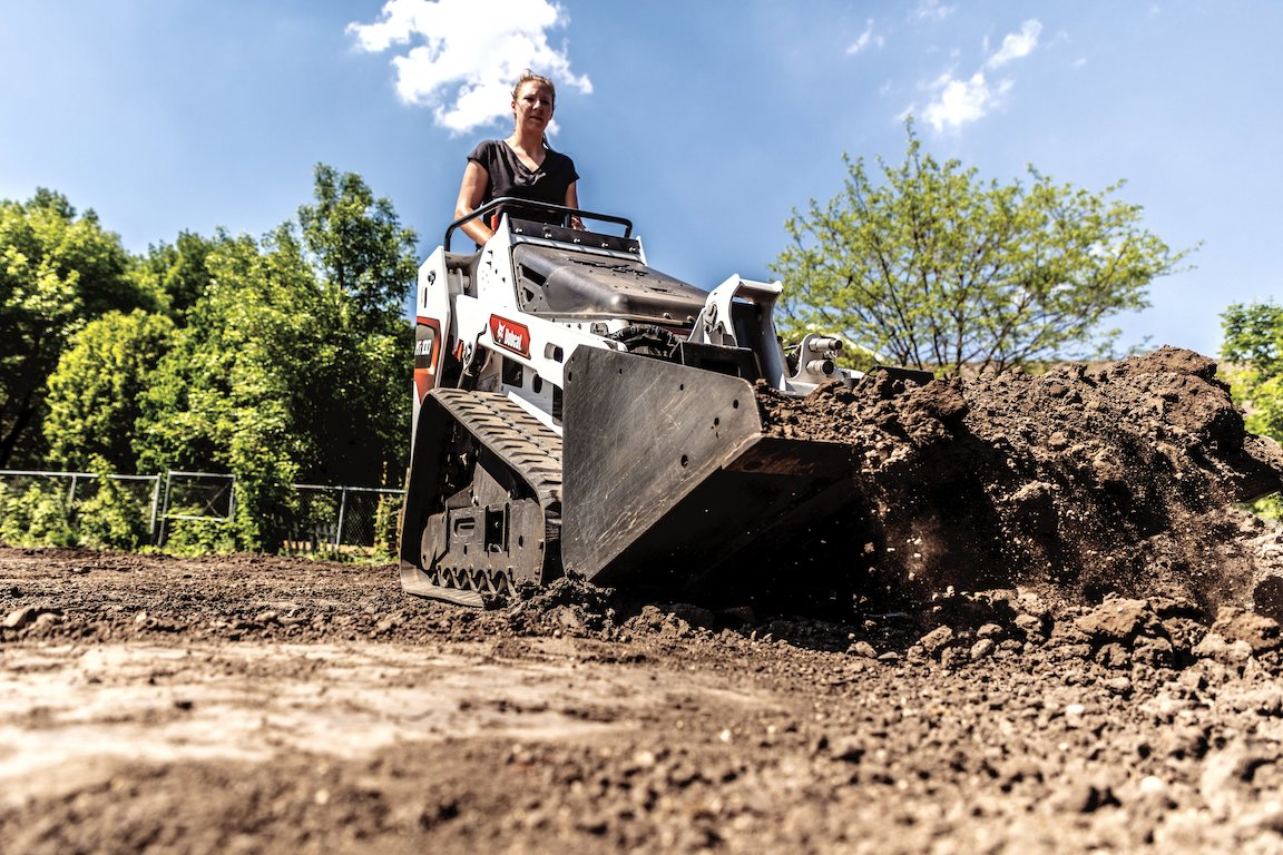 The Bobcat MT100 has an operating weight of 3,390 pounds. Standard equipment includes removeable counterweights that can be mounted to either the undercarriage or the rear uprights to increase lifting performance. Hydraulic pressure is 2,900 psi. Width is 36 inches with narrow tracks and 41 inches with optional wide tracks. Height is 54.6 inches.
