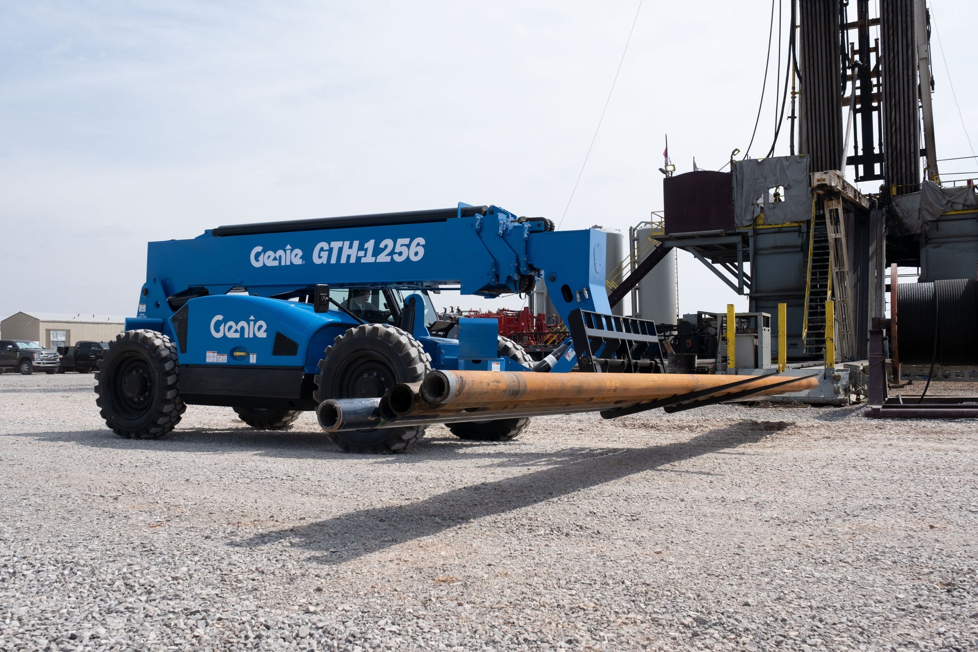 Genie GTH-1256 with black wheels carrying load