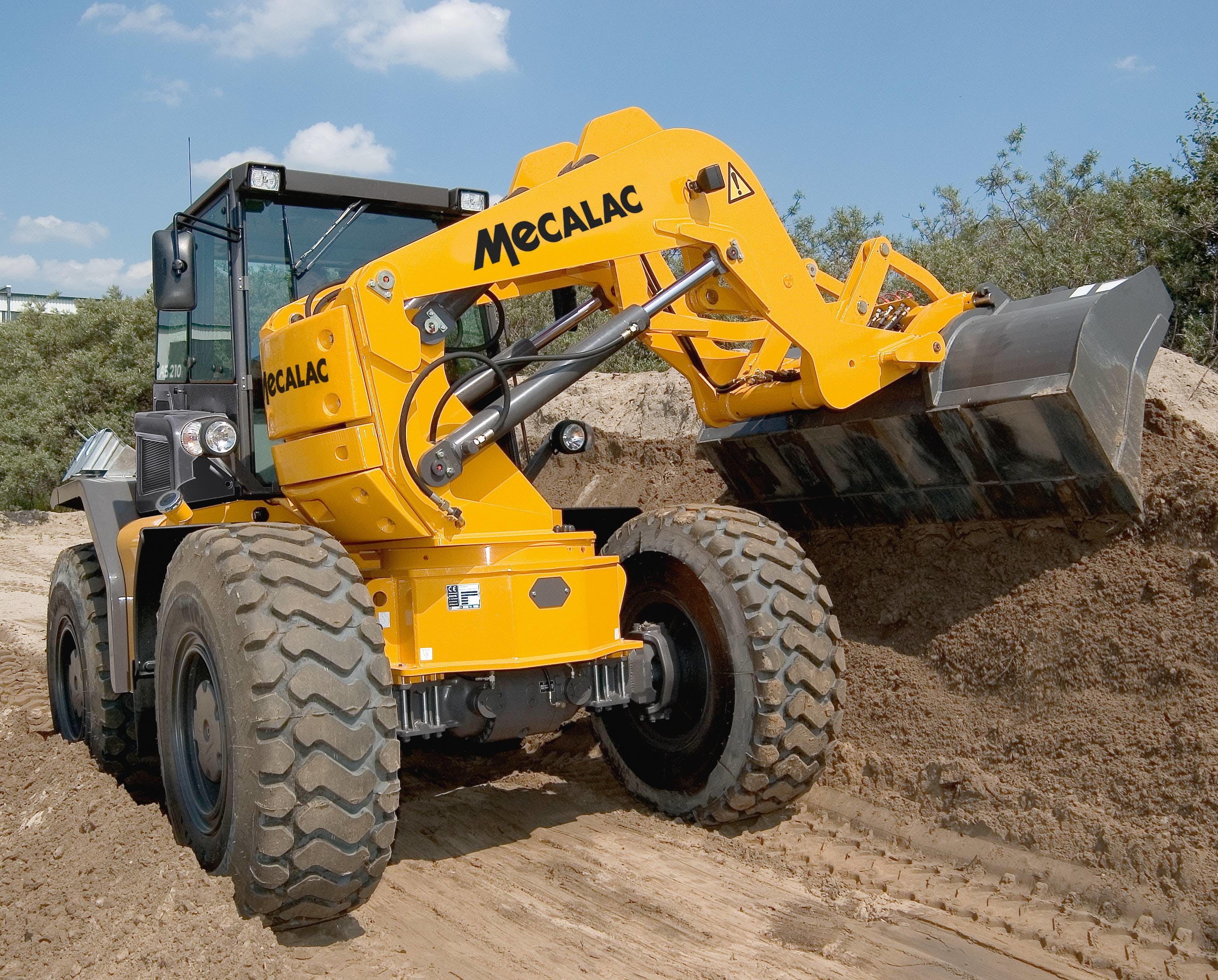 Mecalac AS210 wheel loader digging in pile of dirt