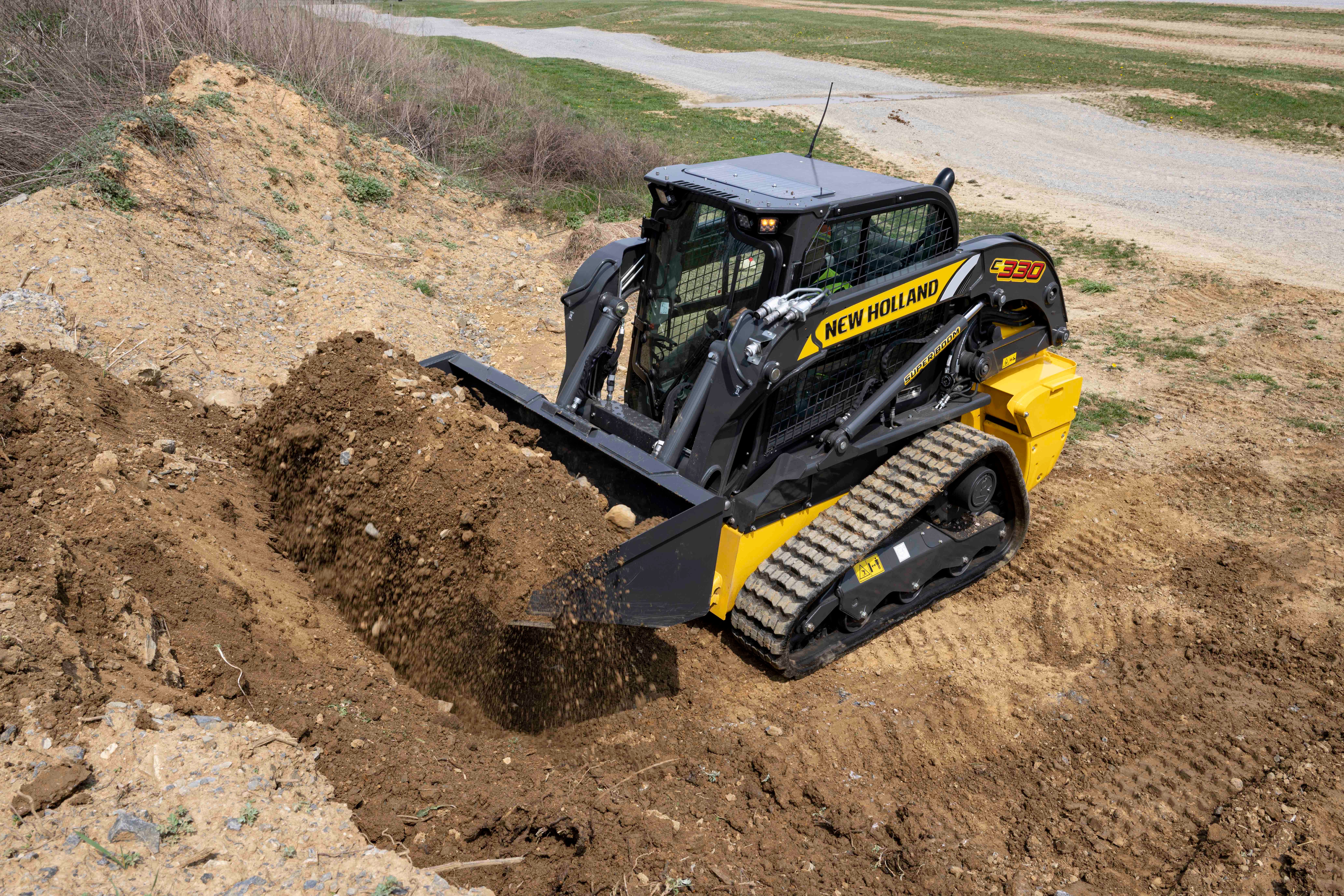 New Holland C330 compact track loader bucketful of dirt